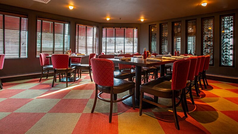 Dining room with long set table and view of wine room